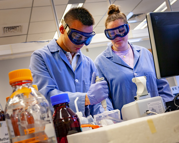 Two students conducting a lab experiment